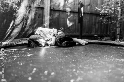 child laying on trampoline