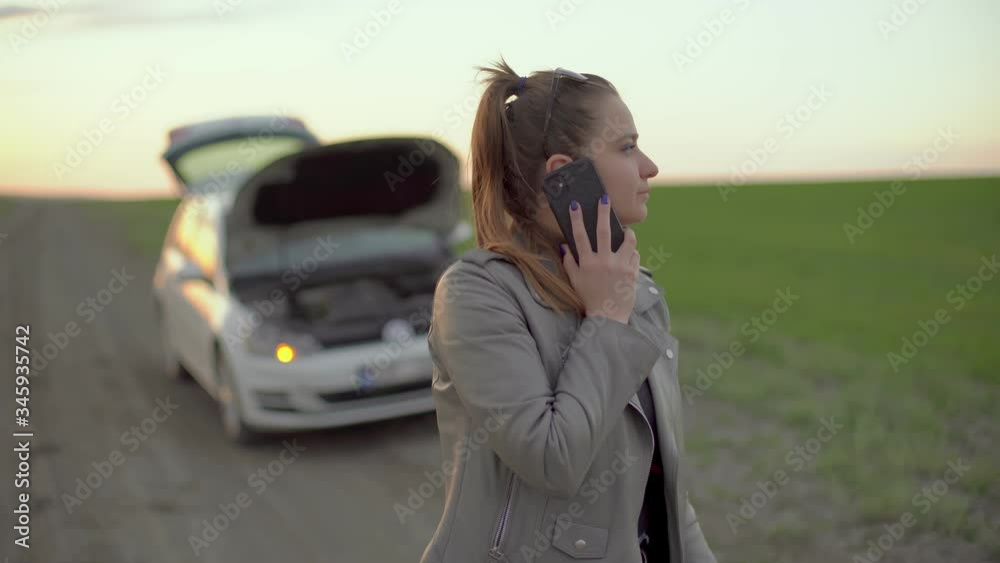 The girl appears in the video frame , with a soiled face,
A car with yellow emergency lights on , on a blurred background.Very desperate and stressed young woman calls the car service.
The girl appears in the video frame , with a soiled face,
A car with yellow emergency lights on , on a blurred background.Very desperate and stressed young woman calls the car service.