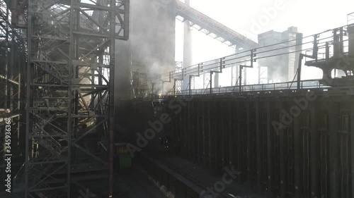 the coke pusher pushes the coke. Coke oven battery. coke and chemicals plant. drone flight over the plant