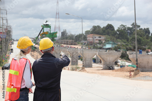 Engineer on site, they are working at building construction area.