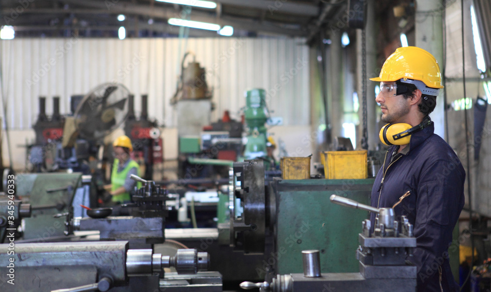 Factory Engineer operating big machine cut off material for industry concept Factory Engineer operating big machine cut off material for industry concept