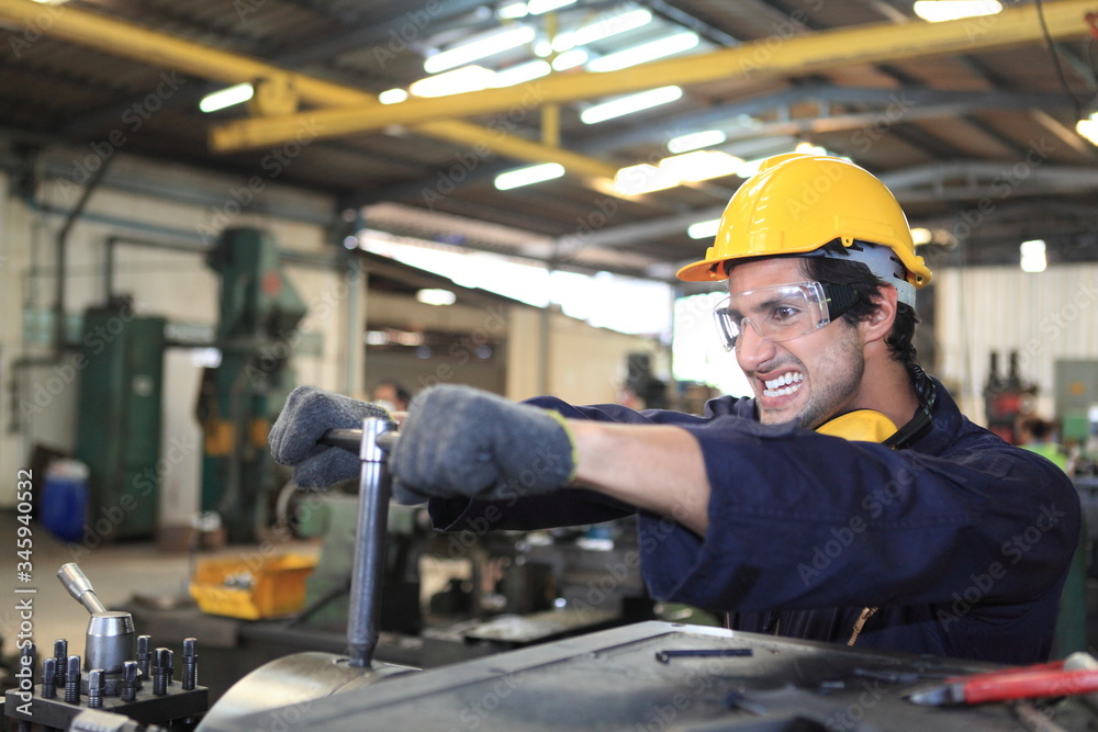 Factory Engineer operating big machine cut off material for industry concept Factory Engineer operating big machine cut off material for industry concept