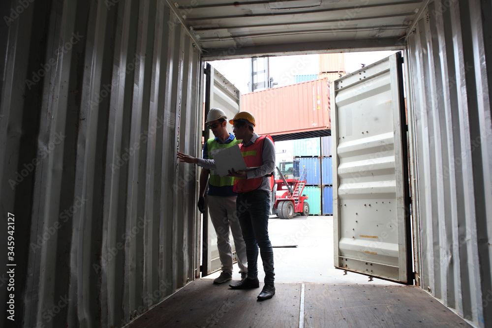 Engineering group working and they are loading container for support logistics and import export business