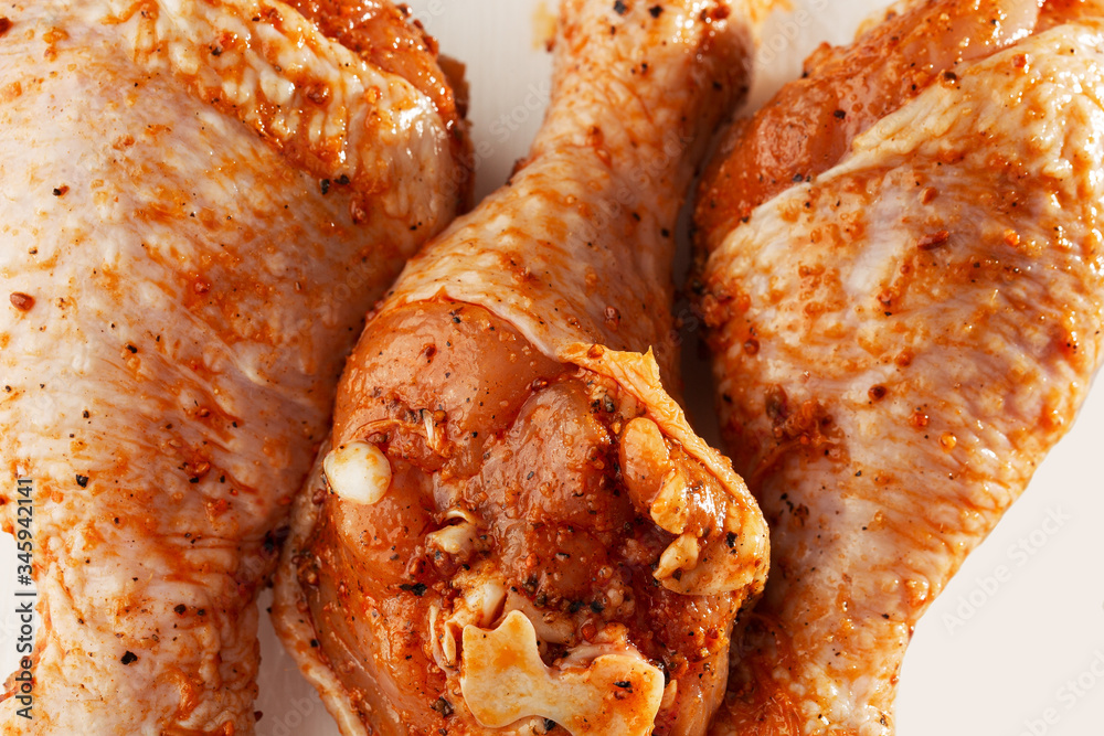 Raw drumsticks on white background. Chicken legs. Raw chicken marinated legs. Top view. Food Background. Cooking content. Uncooked meat. Meat shop concept. Raw drumsticks on white background. Chicken legs. Raw chicken marinated legs. Top view. Food Background. Cooking content. Uncooked meat. Meat shop concept.