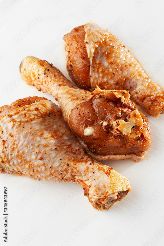 Raw drumsticks on white background. Chicken legs. Raw chicken marinated legs. Top view. Food Background. Cooking content. Uncooked meat. Meat shop concept. Raw drumsticks on white background. Chicken legs. Raw chicken marinated legs. Top view. Food Background. Cooking content. Uncooked meat. Meat shop concept.
