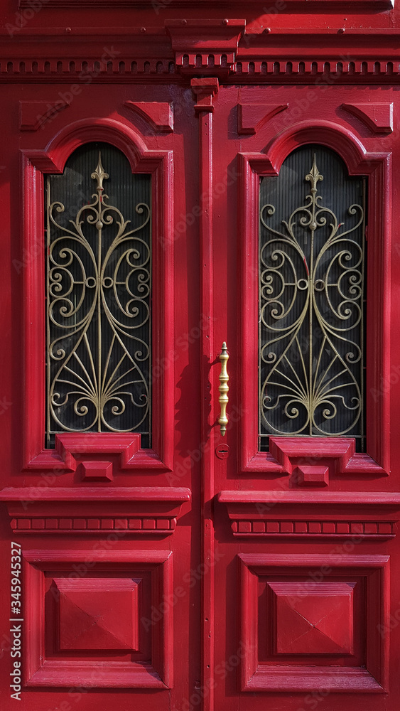 red door in the temple. Ornate red double door of historic building in European city Odessa of Ukraine