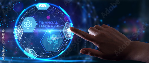 Fintech -financial technology concept.Young businessman select the icon Fintech on the virtual display.