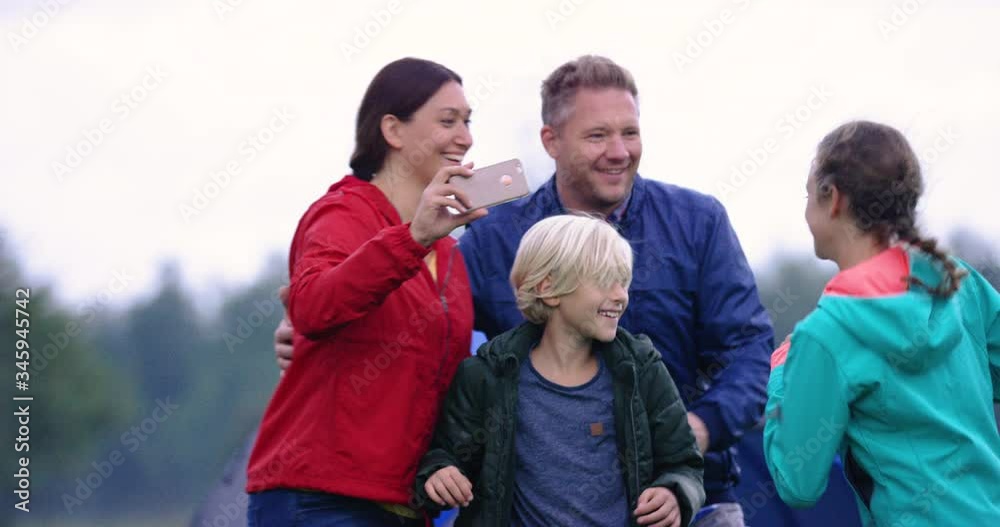 4K Medium Slow Mo Of Happy Family Running And Taking A Photo Together 4K Medium Slow Mo Of Happy Family Running And Taking A Photo Together