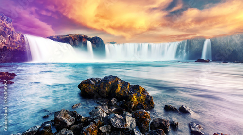 The Incredible landscape of Godafoss waterfall  in North-Iceland with colorful sky during sunset. Amazing nature landscape of Iceland. Iconic location for landscape photographers. Creative Image