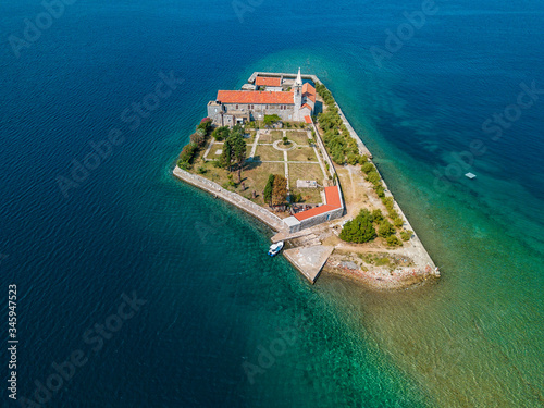 Aerial view of the island of Notre Dame de la Miséricorde, monastery in the Bay of Kotor near the island of Sveti Marko, Montenegro. Ostrvo Gospa od Milosrda. Fisherman fishing photo