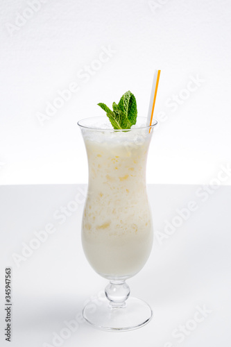 Glass of fresh healthy pineapple smoothie. White Background isolated