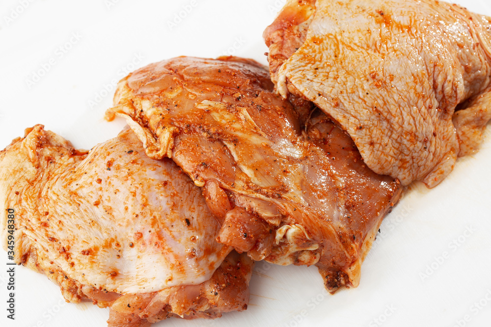 Free range Boneless chicken thighs on stone table. Raw chicken marinated thigh . The view from the Top. Food Background. Copy space. Cooking content. Meat shop.