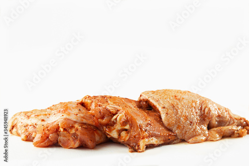 Obraz na płótnie Free range Boneless chicken thighs on stone table. Raw chicken marinated thigh . The view from the Top. Food Background. Copy space. Cooking content. Meat shop. w salonie