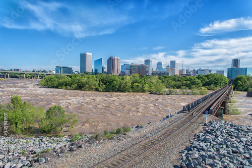 Morning view of the Richmond, Virginia skyline and railroad bridge from across the flooding James River.