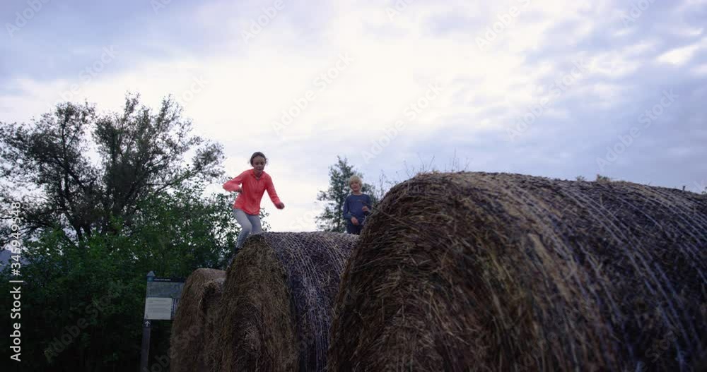 4K Of Girl Running On Top Of Hay Bales While Her Dad And Brother Watch Her 4K Of Girl Running On Top Of Hay Bales While Her Dad And Brother Watch Her