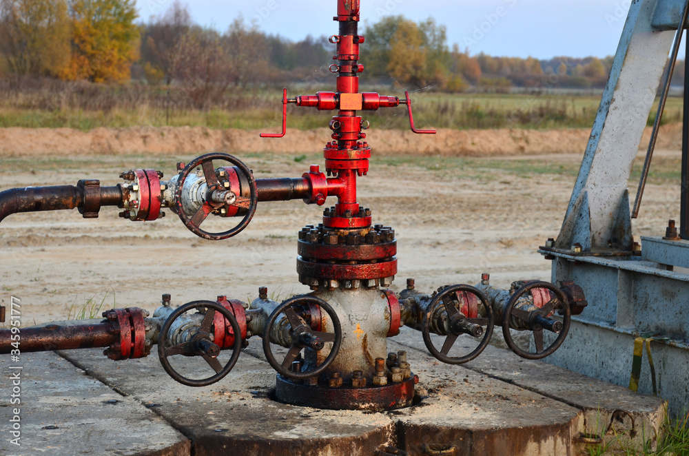 Industrial piping with steel flanges and bolts on oil field. Fuel pipes