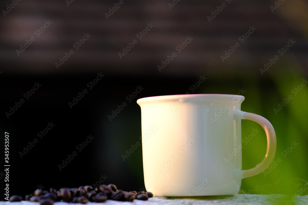 Coffee cup and coffee beans on wooden table background Coffee cup and coffee beans on wooden table background