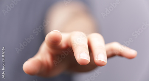 A man hand touching virtual screen, modern background concept , can put your text at the finger, copy space. © vegefox.com