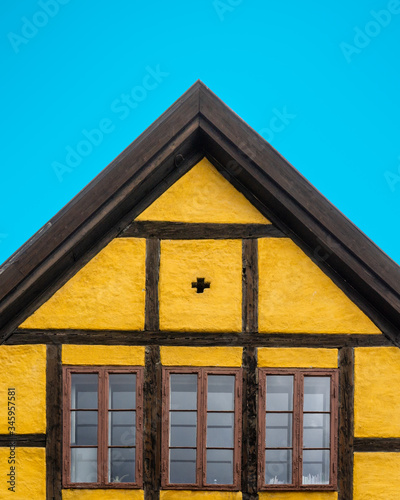 Photography Yellow half-timbered old house under clear blue sky