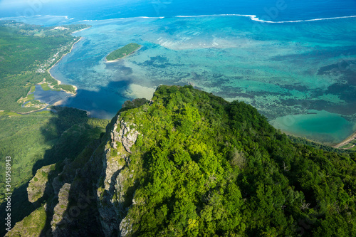 Fototapeta Naklejka Na Ścianę i Meble -  Aerial view to the top of the mountain of Le Morne Brabant and the blue lagoon. Mauritius. Picture taken from helicopter