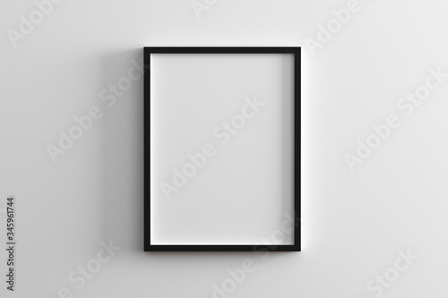blank frame on white wall mock up, vertical black poster frame on wall,  picture frame isolated on a wall, mock up for picture or photo frame,  empty frame on bright wall, 3d render