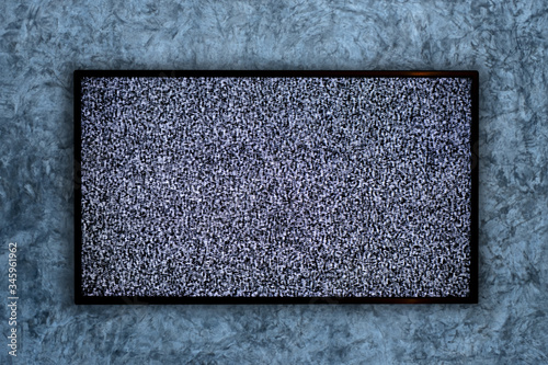 TV on the concrete wall and no signal sign on a Television screen