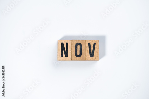 " NOV " text made of wooden cube on White background.