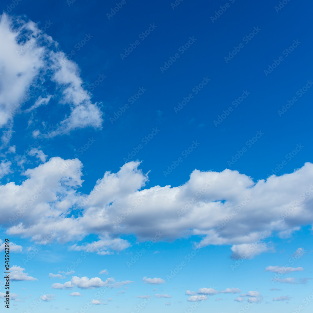 group of white cumulus clouds in the blue sky as a natural background