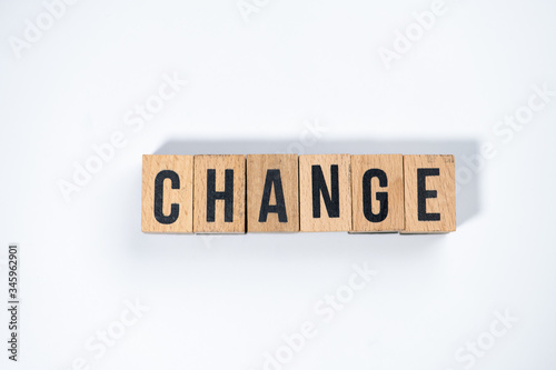 " CHANGE " text made of wooden cube on White background.