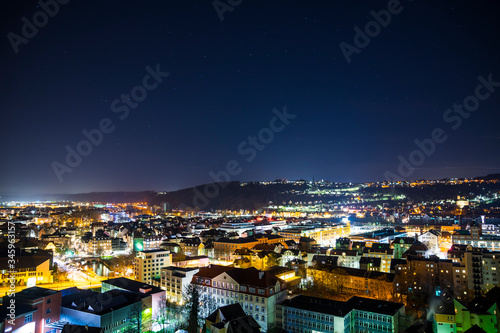 Germany, Dark starry sky over old town buildings of medieval city esslingen am neckar, aerial view above the houses and roofs by night