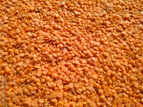 Red raw organic lentils texture. Food ingredient background. Nepal