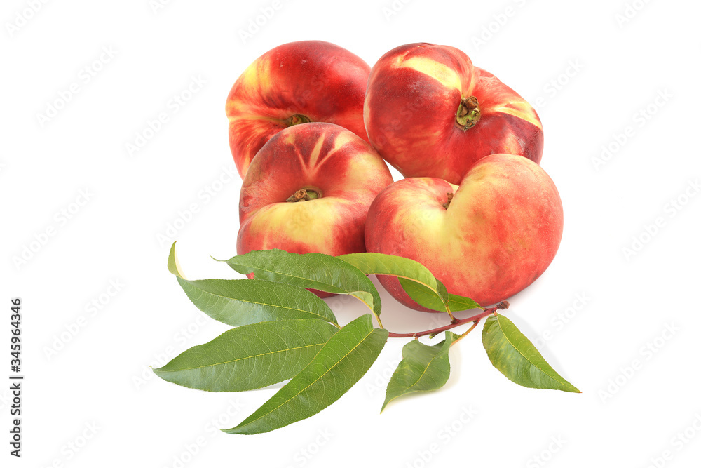 Four flat fig peaches with sprig isolated on white Four flat fig peaches with sprig isolated on white