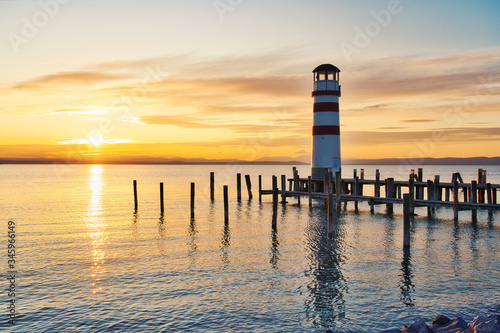 Scenic sunset at idyllic lake Neusiedlersee with old Podersdorf Leuchtturm lighthouse, Burgenland, Austria