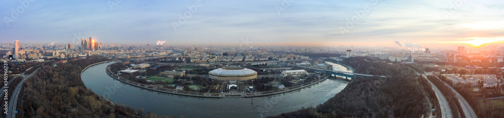 Aerial view of stadium Luzhniki and Moskva river. Moscow-city towers on the horizon. Beautiful spring sunrise over the city.