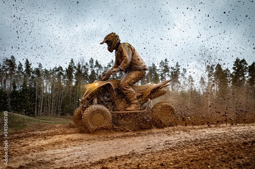 Quad bike in mud. ATV Rider in the action. photo