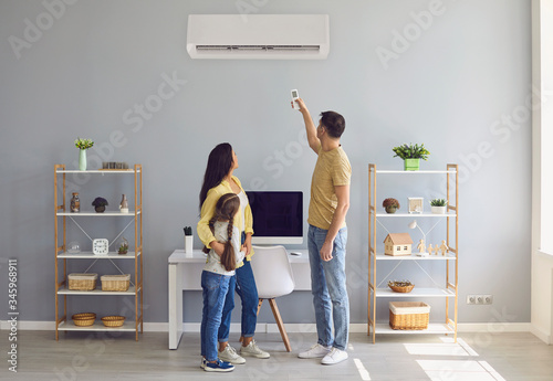 The family uses air conditioning at home. Back view.