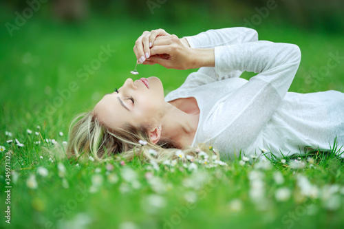 Beautiful woman with a flower. Girl with camomiles. Beautiful woman portrait.