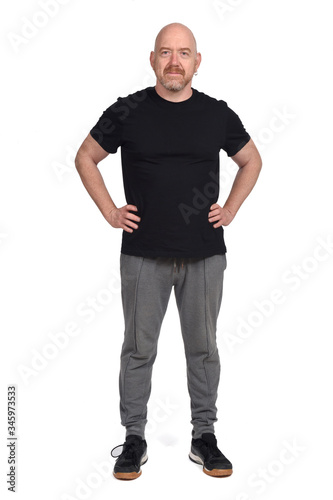 man with sportswear and hands on hip on white background © curto