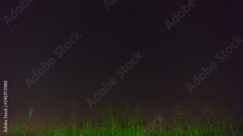 Man stands in the field at night in the starry sky background, Blagoveshenskaya village, Anapa, Russia. © Viacheslav