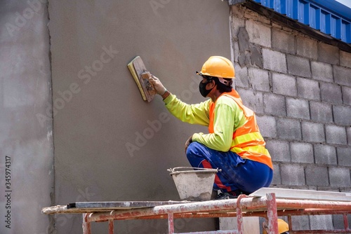 mason rural thailand Plastering concrete to build wall background industrial worker with plastering tools renovating house concept quality