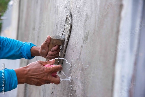 mason rural thailand Plastering concrete to build wall background industrial worker with plastering tools renovating house concept quality