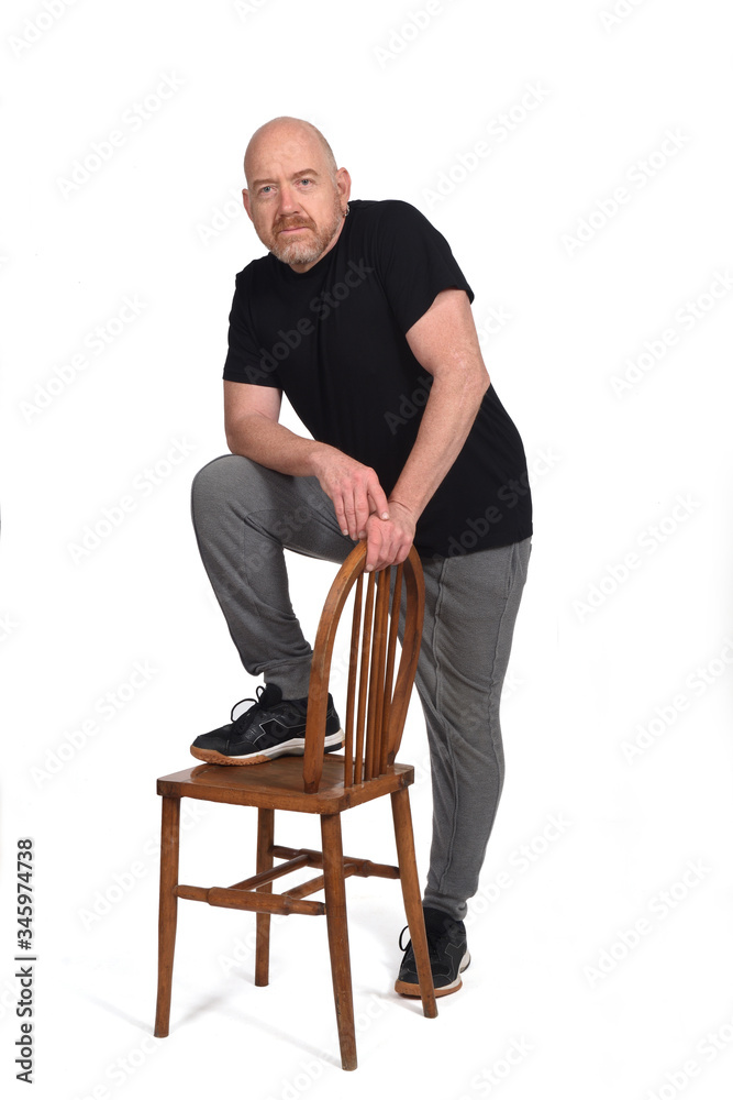 man standing with a chair in white background man standing with a chair in white background