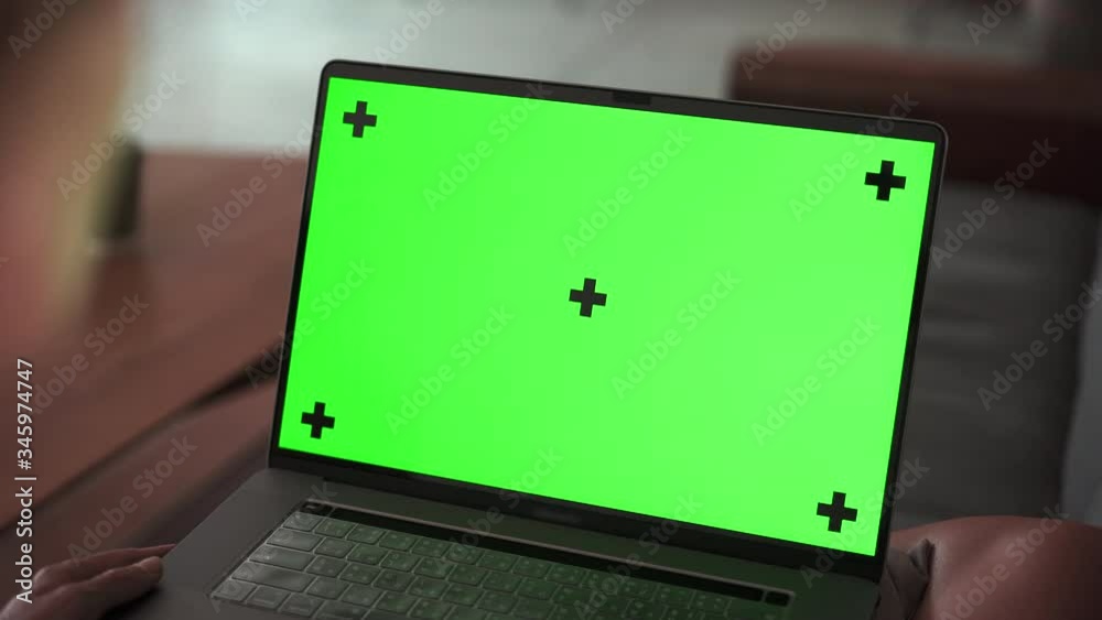  Zoom in on laptop Green Screen Mockup Girl lying down with notebook on couch and watching on screen