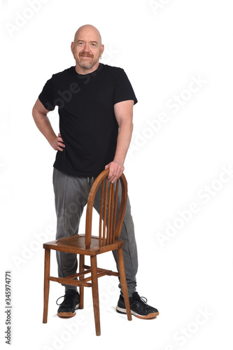 man standing with a chair in white background
