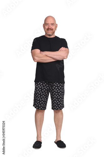 man in short pant pajamas on white background, arms crossed © curto