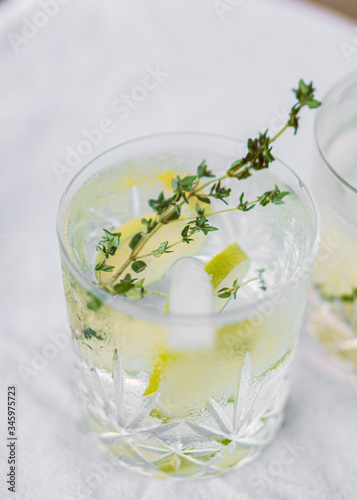 Glass of water with lime and thyme