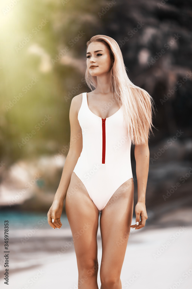 Portrait of beautiful girl posing on the beach in the hot sun Portrait of beautiful girl posing on the beach in the hot sun