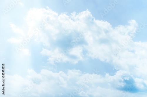 Fluffy white clouds on a clear blue background float in the sky. Spring-summer. Divine view. Concept steady pulse  calm breathing.