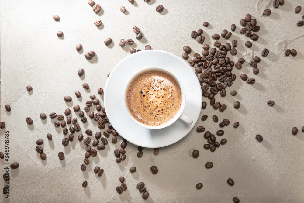 Fototapeta Cup of coffee cappuccino with coffee beans on a table vintage background