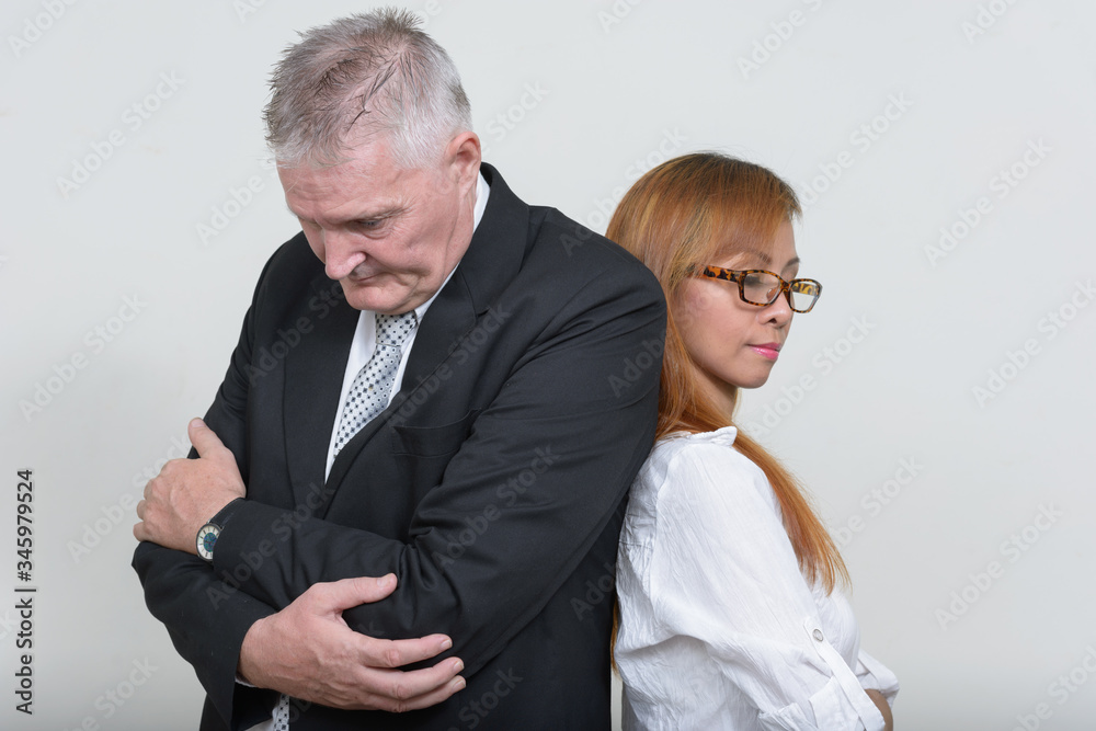 Mature multi ethnic business couple working together Mature multi ethnic business couple working together